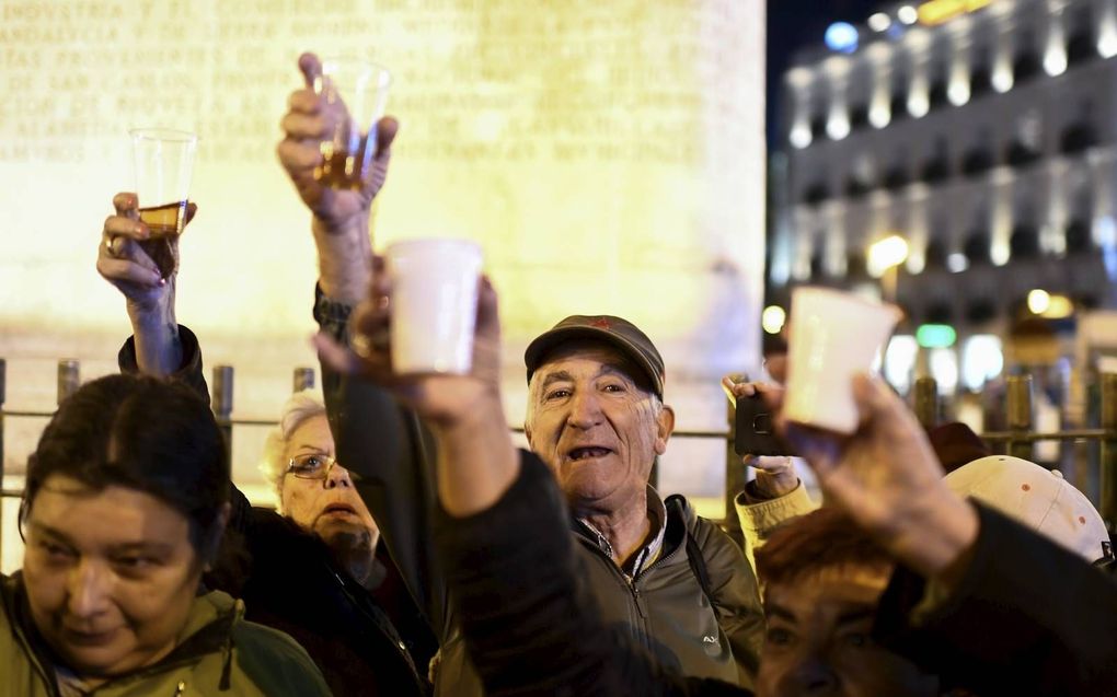 Mensen proosten op de herbegrafenis van de Spaanse dictator Francisco Franco op het Puerta del Solplein in Madrid.  beeld AFP, Oscar del Pozo