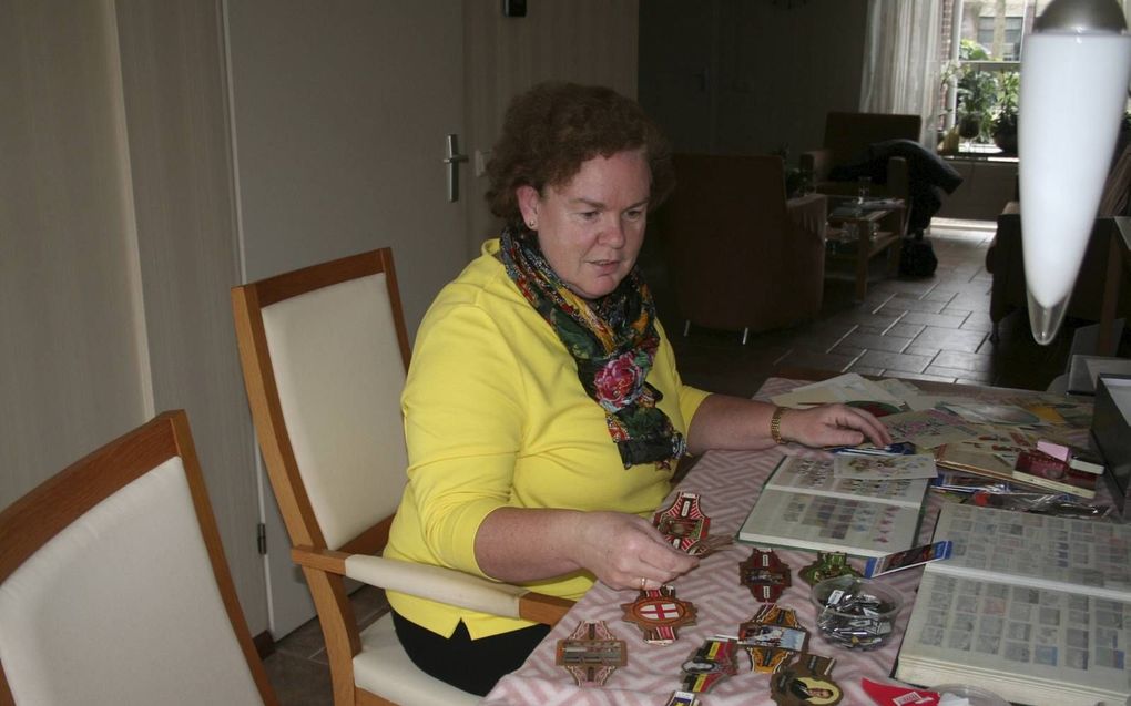 Liset Versluis zoekt postzegels en sigarenbandjes uit voor de verzamelbeurs op 21 maart in Leerdam. beeld André Bijl