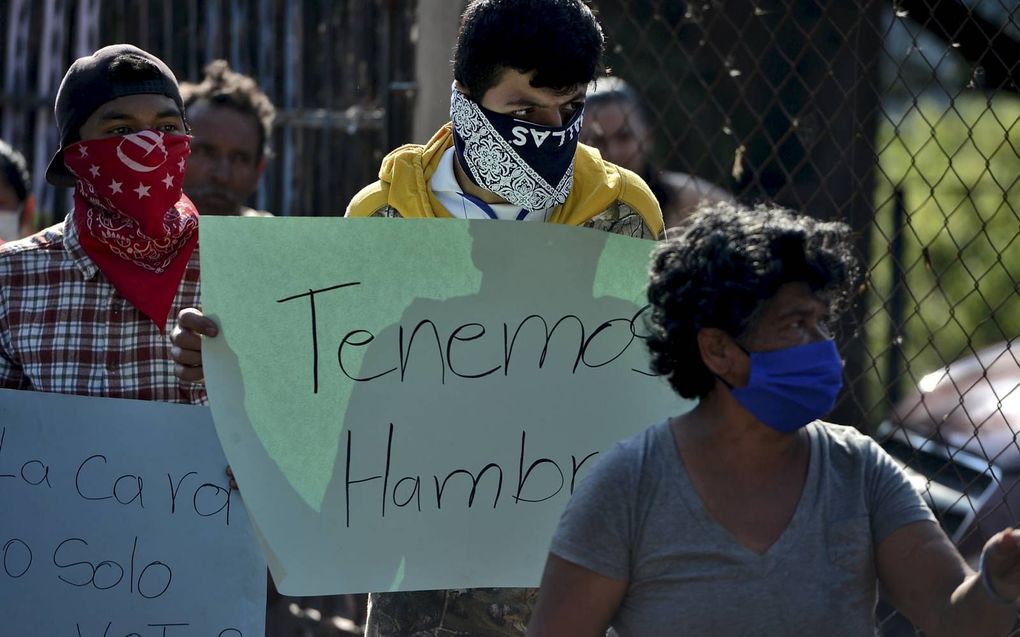 „Huidhonger is niet fijn, maar je kunt ermee leren leven. Honger is verschrikkelijk en kost je je leven.” Foto: tijdens een protest in Honduras laat een man weten: „Wij hebben honger.” beeld AFP, Orlando Sierra