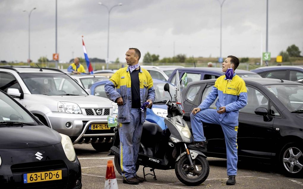 Medewerkers van Tata Steel donderdag tijdens een drive-in-ledenvergadering op de parkeerplaats van De Bazaar in Beverwijk. beeld ANP, Koen van Weel