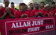 Maleisische moslims protesteren tegen het gebruik van het woord Allah door het rooms-katholieke nieuwsblad The Herald, 2014. beeld EPA, Ahmad Yusni