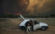 Bosbranden in de omgeving van Athene. beeld AFP, Aris Messinis