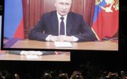 De Russische president Vladimir Poetin houdt virtueel zijn toespraak tijdens de BRICS-top 2023. beeld AFP, Marco Longari