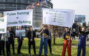 Pulsvissen is goed voor het klimaat, melden de spandoeken van deze aankomende vissers voor het gebouw van het Europees Parlement in Straatsburg. Met hun vaders en grootvaders kwamen ze dinsdag naar de Franse stad om te proberen een dreigend verbod op de i