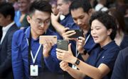 Bezoekers experimenteren met de nieuwe iPhone 11 tijdens de presentatie op het hoofdkantoor van Apple in Cupertino, Californië.  Beeld AFP Josh Edelson