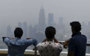 Steden zorgen voor 70 procent van de uitstoot van broeikasgassen. Foto: smog in de Maleisische hoofdstad Kuala Lumpur. beeld AFP, Mohd Rasfan