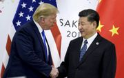 Xi Jinping (r.) en Donald Trump. beeld AFP, Brendan Smialowski