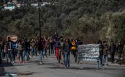 Vluchtelingen demonstreerden maandag bij Moria, na botsingen met de oproerpolitie. Hulpverleners konden het kamp niet in.   beeld AFP, Angelos Tzortzinis