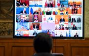 De Italiaanse minister Gisuseppe Conte, donderdag tijdens een buitengewone videoconferentie met leiders van de G20 over de coronacrisis. beeld AFP, Palazzo Chigi Press Office