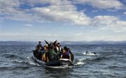 Migranten arriveren per rubberboot op het Griekse eiland Lesbos nadat ze op 13 oktober 2015 vanuit Turkije de Egeïsche Zee zijn overgestoken. beeld AFP, Dimitar Dilkoff