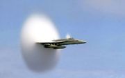 Een F/A-18 van de US Navy vliegt sneller dan de geluidssnelheid. De witte wolk wordt gevormd door een verlaagde luchtdruk en dalende temperatuur rond de staart van het vliegtuig.  beeld Wikimedia, John Gay/U.S. Navy