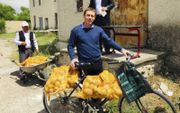 Een Moldavische voorganger die gemeenteleden bezoekt, neemt uit Nederland afkomstige aardappels voor hen mee. beeld stichting Movu-Moldova