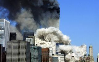 Brandend WTC na de aanslagen. beeld AFP, Hennny Ray Abrams