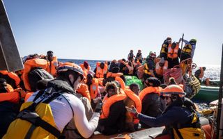 Migranten die al een week op de Middellandse Zee ronddobberen, worden door hulporganisatie SOS Méditerranée voor de kust van Libië opgepikt. Veel vluchtelingen reizen vanuit Egypte via Libië naar Europa. beeld AFP, Johanna de Tessieres
