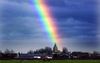 Een regenboog raakt de horizon juist op de kerktoren van Zoelmond (Gelderland). Bij de steeds terugkerende discussies over homoseksualiteit zou de moed je in de schoenen zinken. Maar Hemelvaartsdag werpt daar een ander licht op. beeld William Hoogteyling