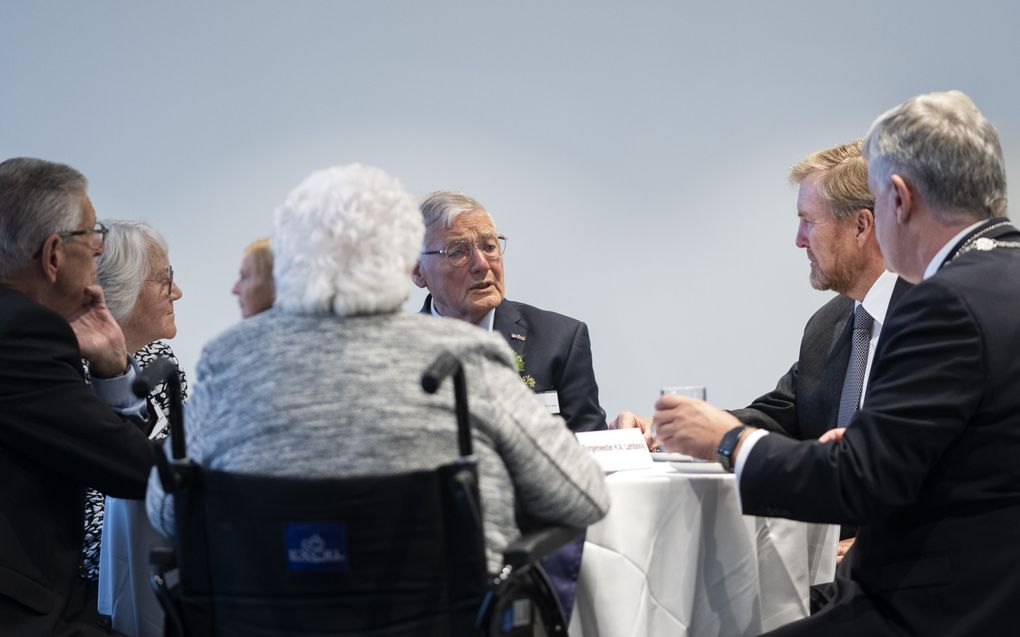 Koning Willem-Alexander spreekt met nabestaanden tijdens de herdenking van de razzia van Putten. beeld ANP, Jeroen Jumelet