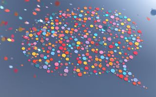 Talrijke veelkleurige tekstballonpictogrammen vallen van bovenaf naar beneden en voegen zich samen tot een grotere tekstballon op een effen achtergrond.