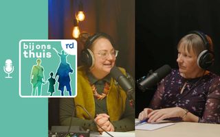 Twee vrouwen in een studio, beide achter een eigen microfoon.