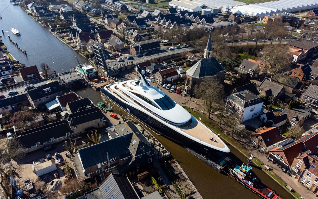 Het superjacht Faith vaart langs de Dorpskerk van Woubrugge, waar Alexander Comrie 38 jaar predikant was. beeld ANP, MediaTV 