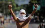Demonstrant in Caracas. beeld EPA