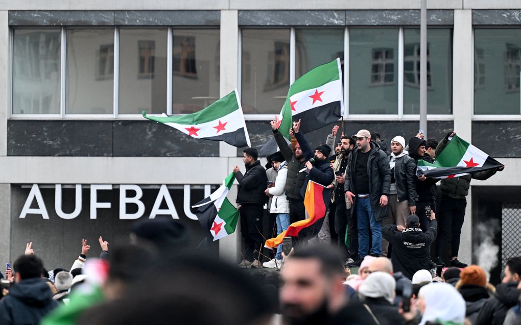 Leden van de Syrische gemeenschap vieren in Berlijn het einde van de heerschappij van de Syrische dictator Bashar al-Assad. beeld AFD, Ralf Hirschberger  