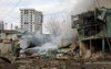 Een Oekraïense brandweerman blust een huis in Charkiv dat getroffen is door een Russische raket. beeld EPA, Sergey Kozlov