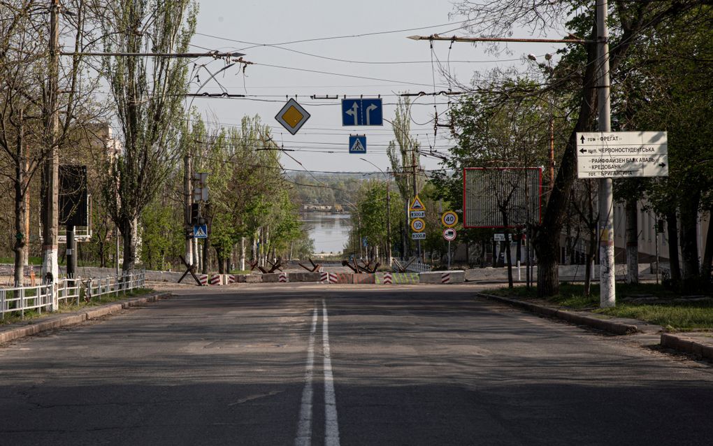 Straatbeeld Cherson. Op de achtergrond de frontlijn: de rivier de Dnipro. In het groene bos houden de Russen zich schuil. beeld Kostyantyn Chernichkin