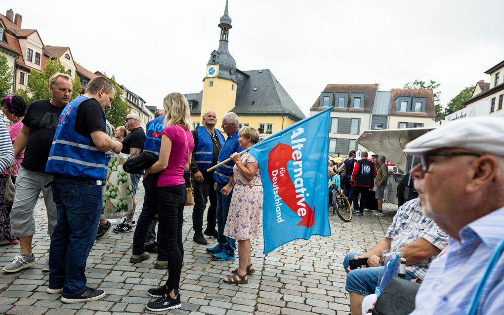 Aanhangers van de extreemrechtse partij Alternative für Deutschland wonen een verkiezingscampagne bij in Apolda, Thüringen. beeld AFP, Jens Schlueter 