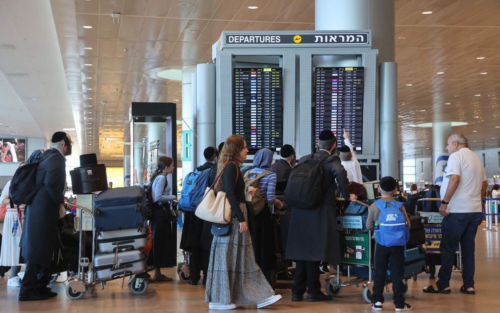 Passagiers wachten maandag op de luchthaven van Tel Aviv of er nog vluchten gaan. Het vliegveld is grotendeels dicht als gevolg van een nationale staking. beeld AFP, Gil Cohen-Magen