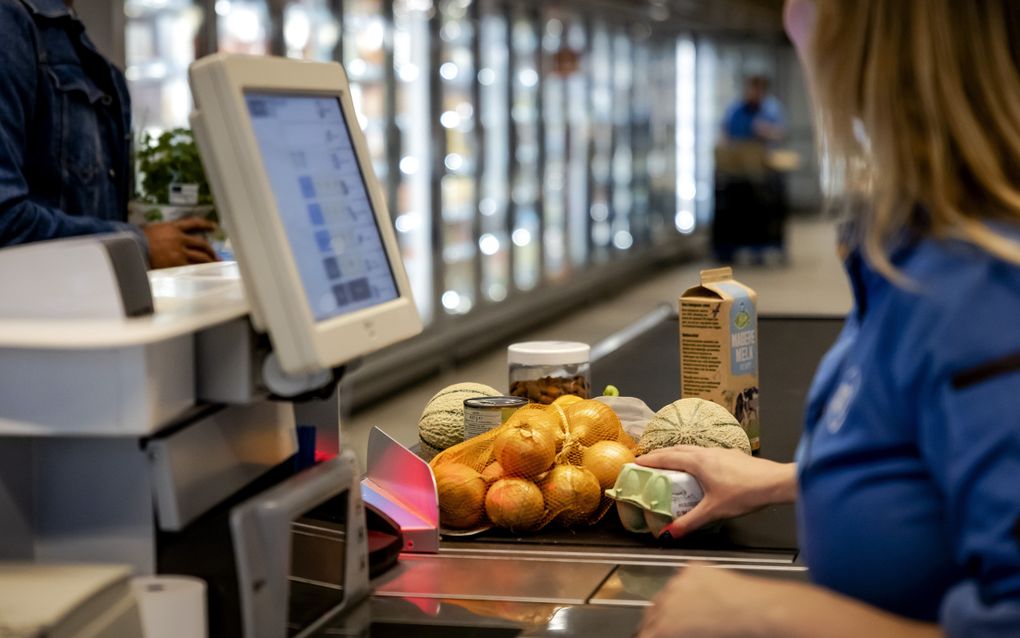 Een kassamedewerkster in een supermarkt scant levensmiddelen. De maatregelen die supermarkten nemen om te voorkomen dat onverkocht voedsel weggegooid moet worden, zijn succesvol. beeld ANP, Robin van Lonkhuijsen. 