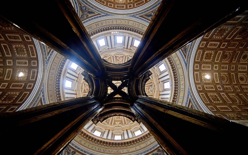 Na een grondige restauratie is de Baldakijn van Bernini in de Sint-Pietersbasiliek te Rome weer uit de steigers. beeld AFP, Filippo Monteforte