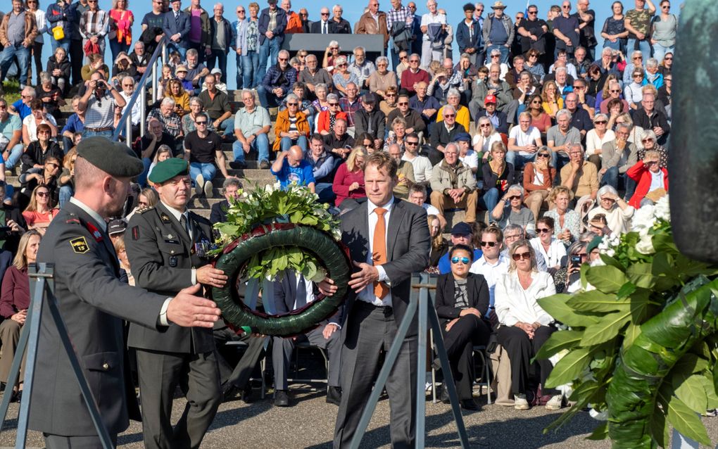 Staatssecretaris Tuinman (r.) en kolonel Smeets (m.) plaatsten de tweede krans. beeld Dirk-Jan Gjeltema