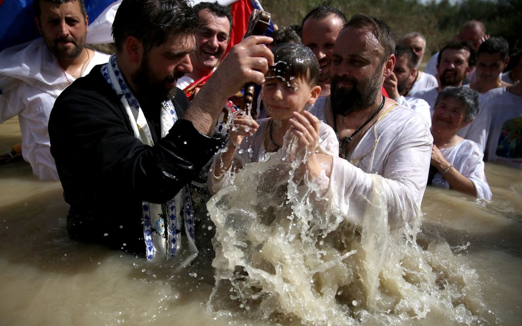 Een kind wordt in de Jordaan gedoopt. beeld AFP, Gali Tibbon