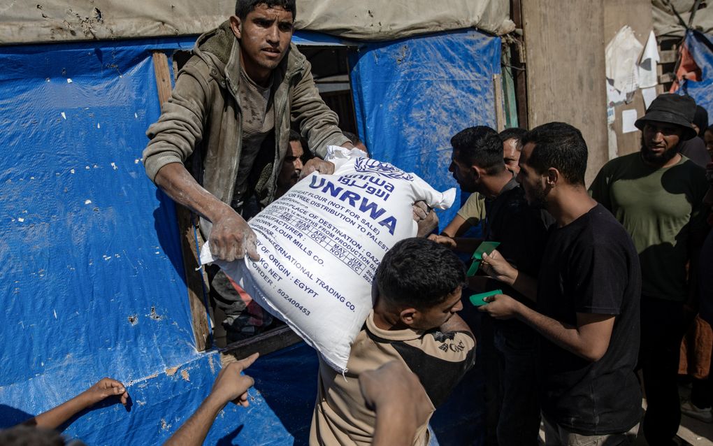 „Terecht heeft het Israëlische parlement de UNRWA de wacht aangezegd.” Foto: Palestijnen krijgen zakken meel van de UNRWA. beeld EPA, Haitham Imad