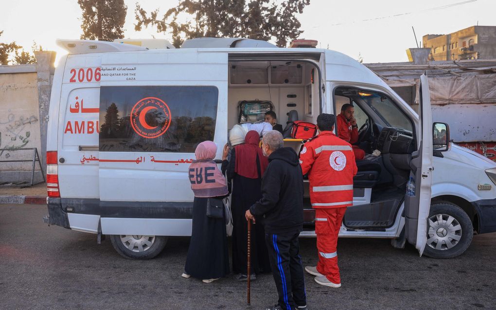 Medewerkers van de Rode Halve Maan verlenen hulp in Khan Younis in de Gazastrook. beeld AFP, Eyad Baba.