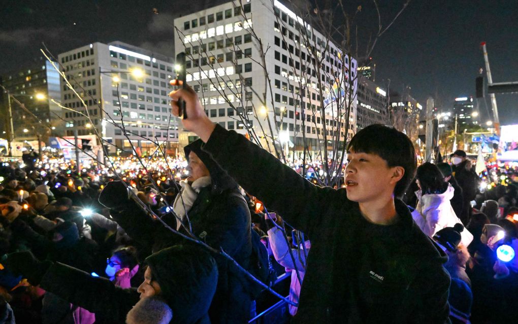 Zuid-Koreanen wachten buiten het parlementsgebouw in Seoul de afzettingsprocedure tegen president Yoon Suk-yeol af. beeld AFP, Jung Yeon-je.