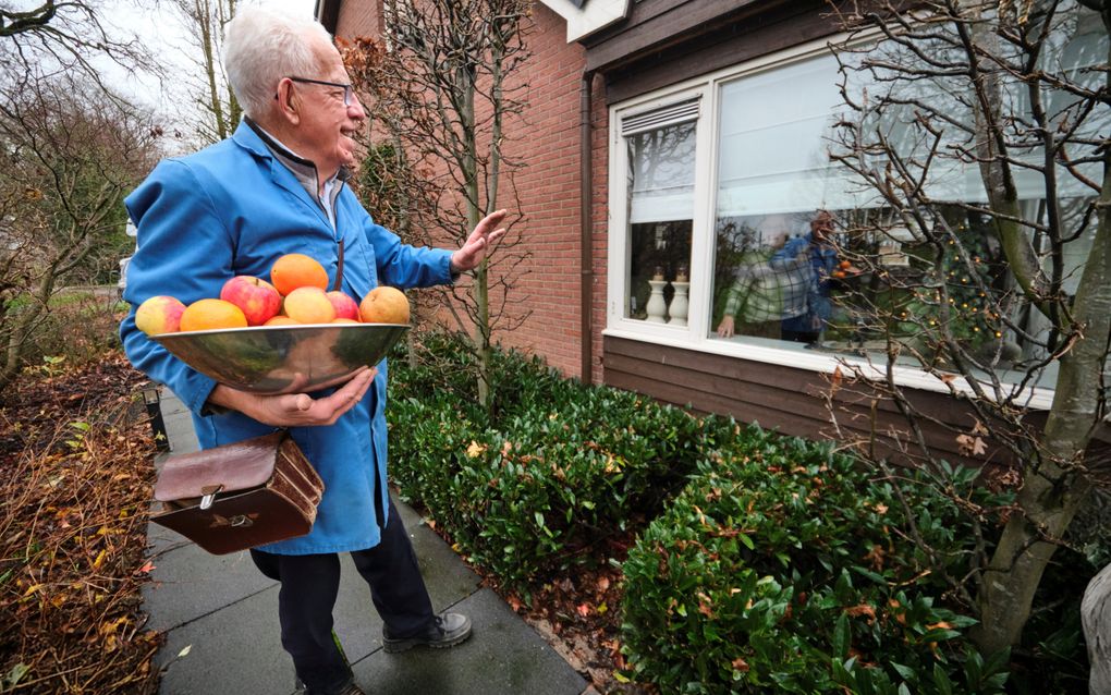 Groenteboer Henk Slappendel (78) uit Reeuwijk zwaait naar een klant. beeld Fred Libochant Fotografie