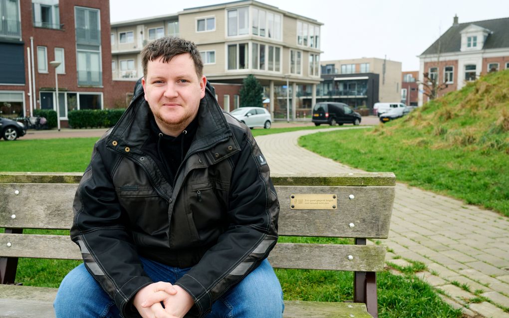 Davey Wensink op het bankje aan de IJssel in Kampen waar een plaquette van 113 Zelfmoordpreventie op is bevestigd. beeld Dick Vos