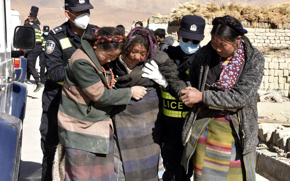 Hulpverleners redden mensen in de door een aardbeving getroffen stad Xigaze in het zuidwesten van China. beeld EPA, Xinhua 