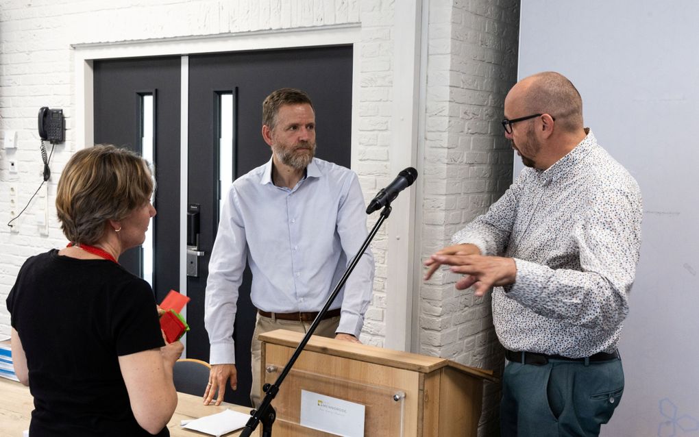 Drie mensen in gesprek.