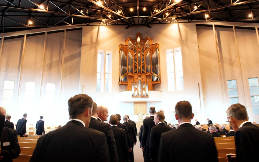 Mannen lopen kerk in.