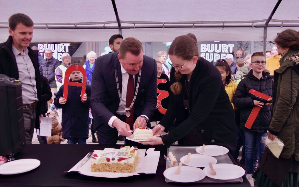 Met het aansnijden van een taart opende burgemeester Gerben Dijksterhuis (m.) de Buurtsuper Borssele. Links dorpsraadvoorzitter Willem Jan Joosse. beeld Van Scheyen Fotografie