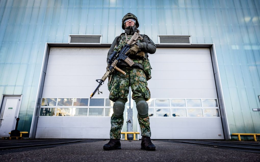 Militair voor een loods. 