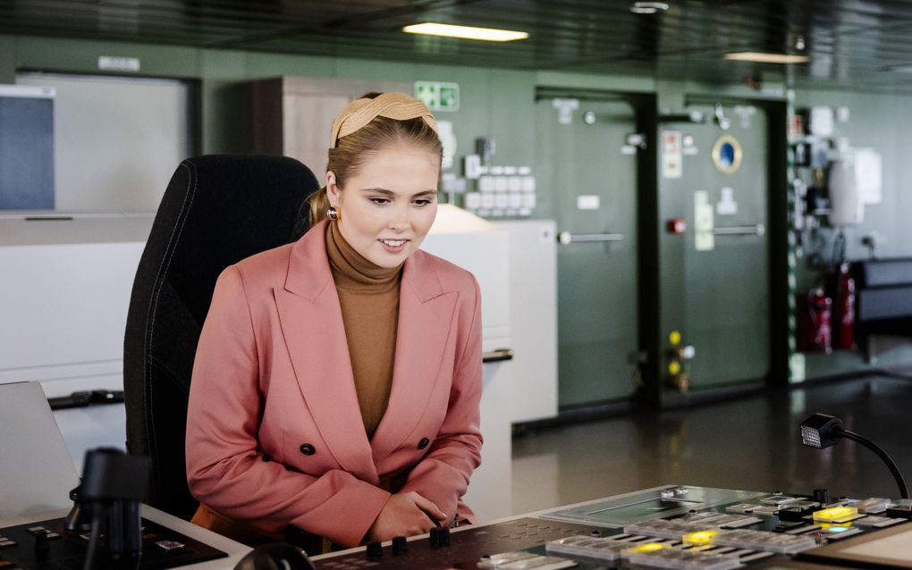 Jonge vrouw kijkt naar knoppen op een machine.