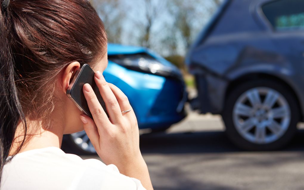 Een vrouw belt om hulp net na een aanrijding met de auto. Mensen die verwondingen hebben opgelopen na een ongeluk en een letselschadevergoeding willen krijgen, kunnen een belangenbehartiger in de arm nemen. beeld iStock