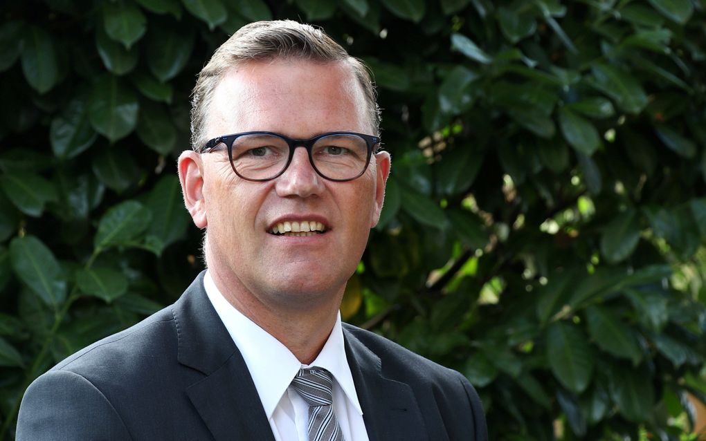 Dominee Mensink, een man met bril. 