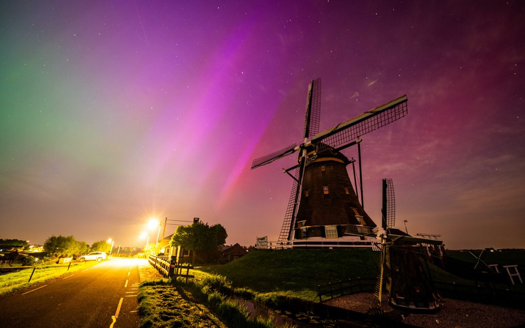 Het noorderlicht is goed te zien boven de Molenviergang van Aarlanderveen. beeld ANP, Josh Walet