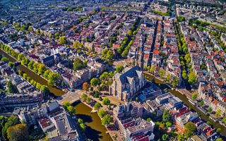 Amsterdam van boven gezien met oranje daken, twee grachten en de Westerkerk.