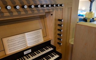 Speeltafel van een orgel met een psalmkoraalboek op de lessenaar.