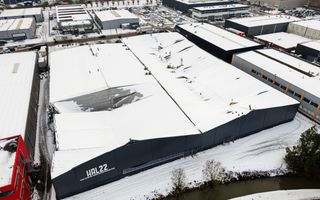 Groot complex met veel sneeuw op het dak waarvan een deel is ingestort. 